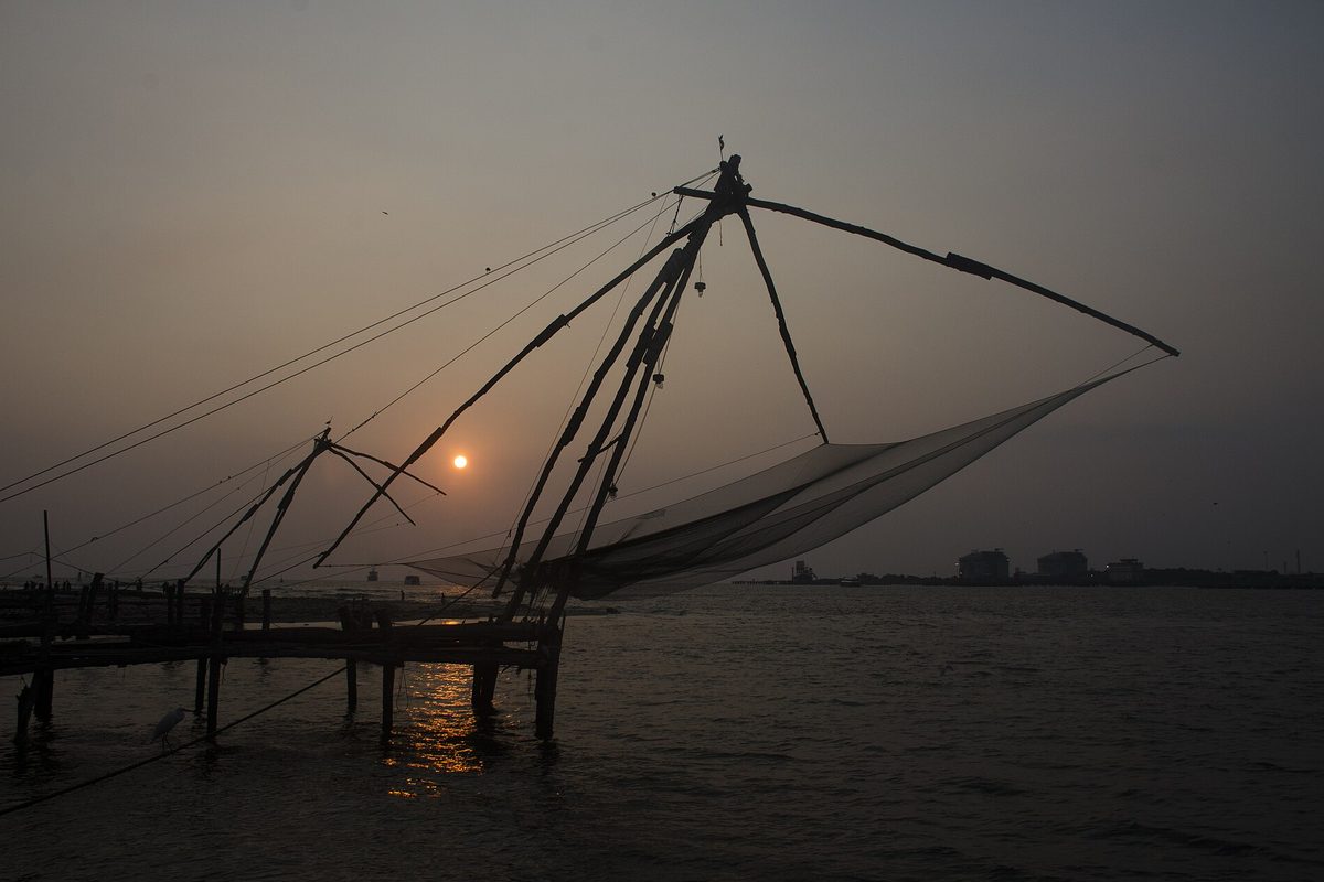 A Chinese fishing net silhouetted against the setting sun at Fort Kochi.