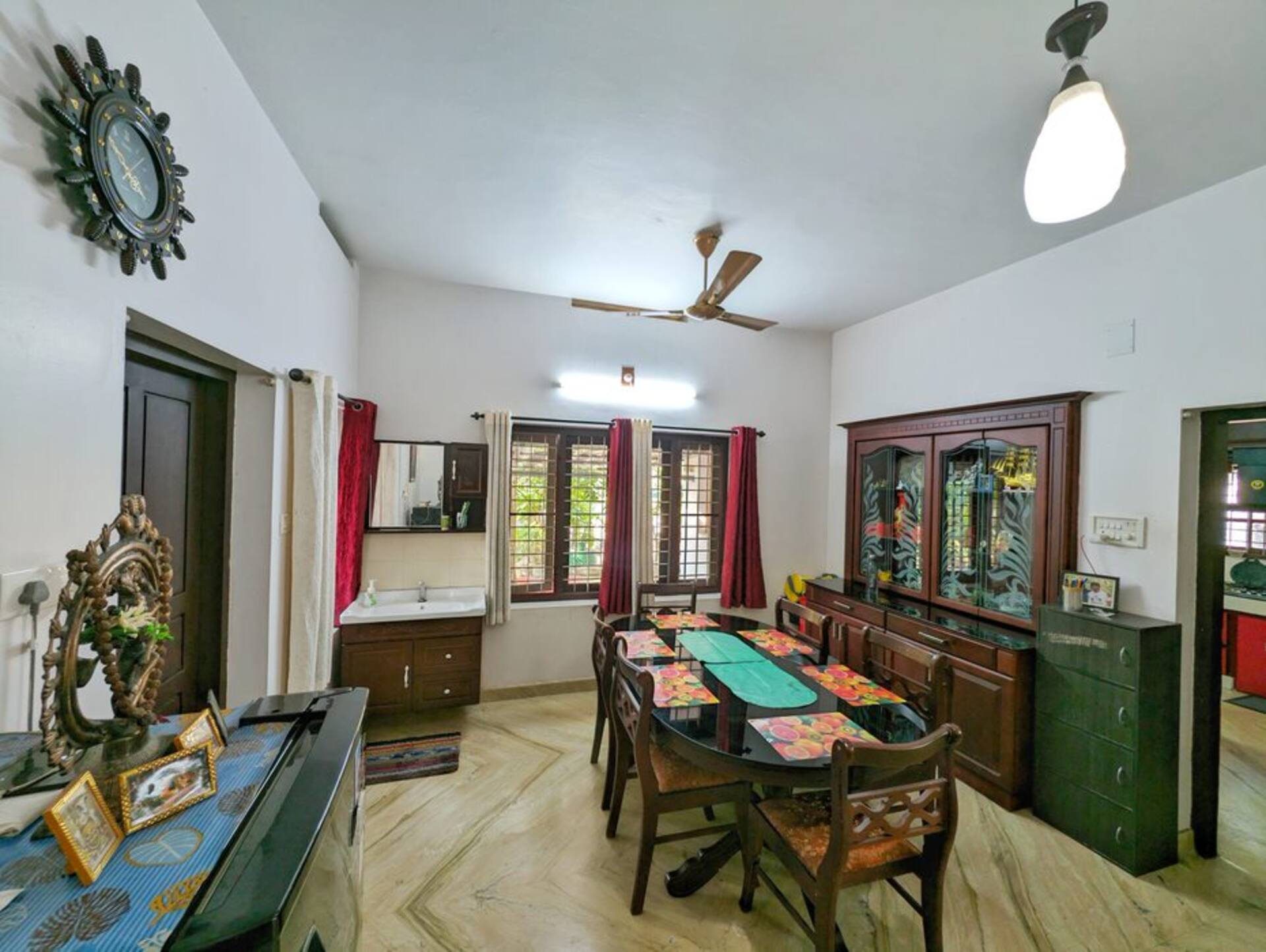 The shared dining area with a long wooden table set for breakfast.
