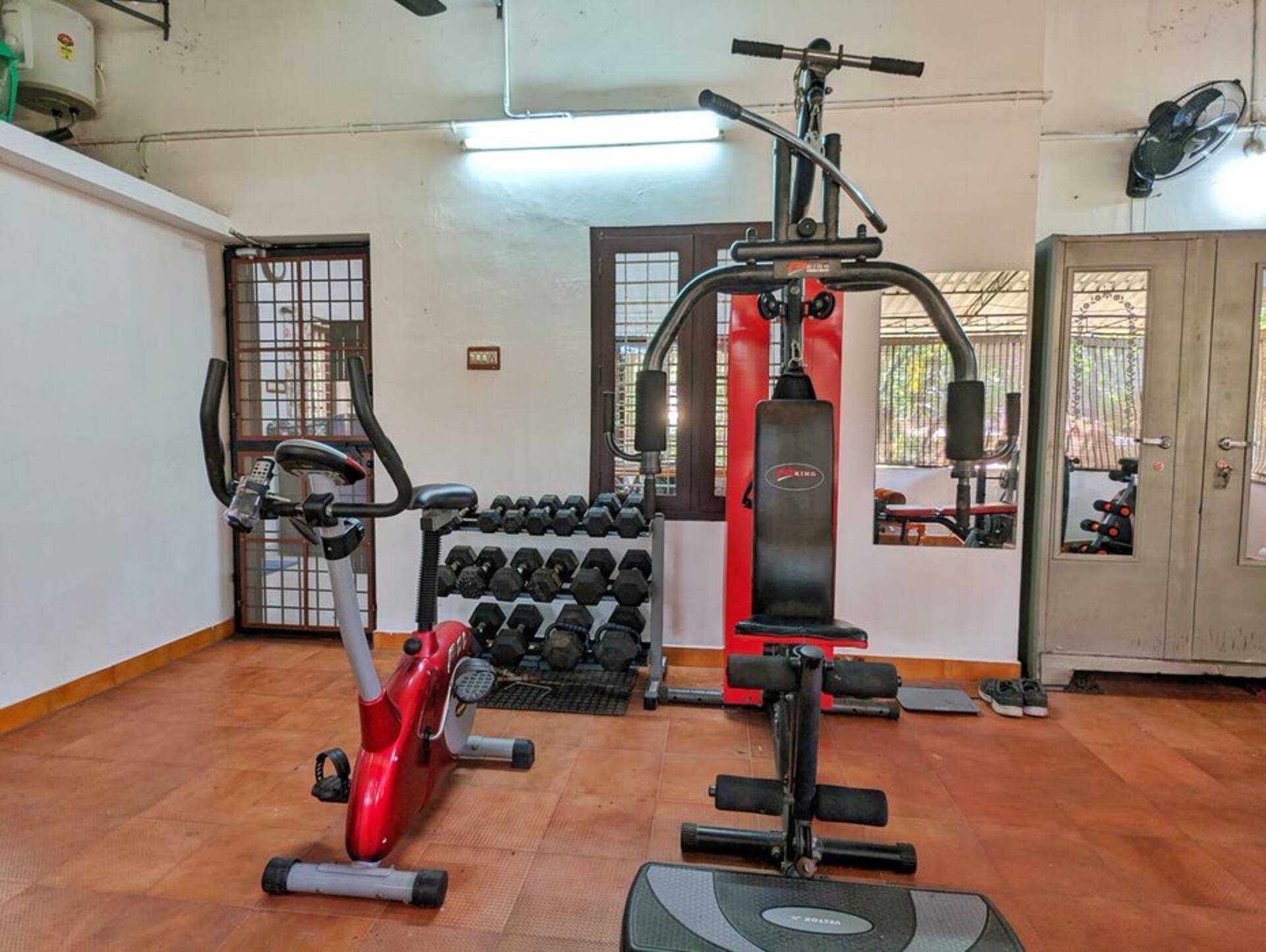 More of the home gym, with an elliptical trainer and yoga mat.
